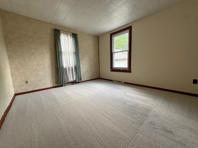 unfurnished room featuring carpet