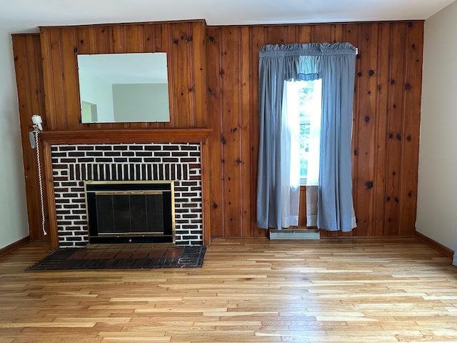 unfurnished living room featuring wooden walls and light wood-type flooring