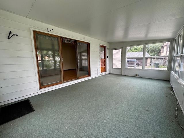 unfurnished sunroom with lofted ceiling