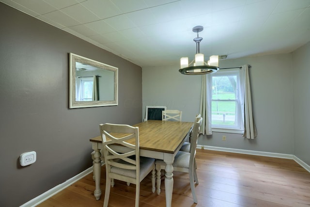 dining area featuring a notable chandelier and light hardwood / wood-style floors