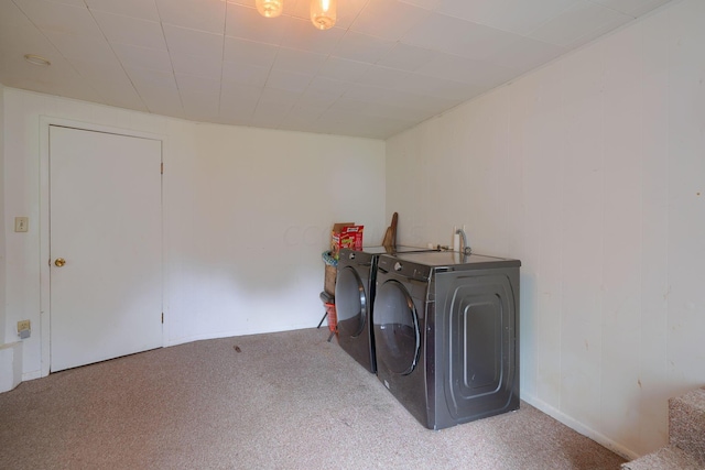 washroom with washer and dryer and light carpet