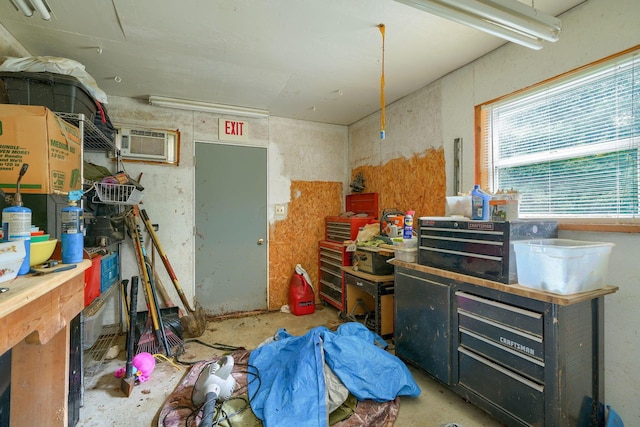 misc room with a workshop area and an AC wall unit