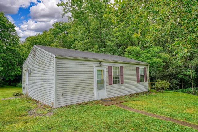 view of outbuilding featuring a yard