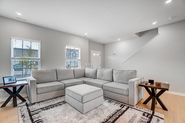 living room featuring plenty of natural light and light wood-type flooring