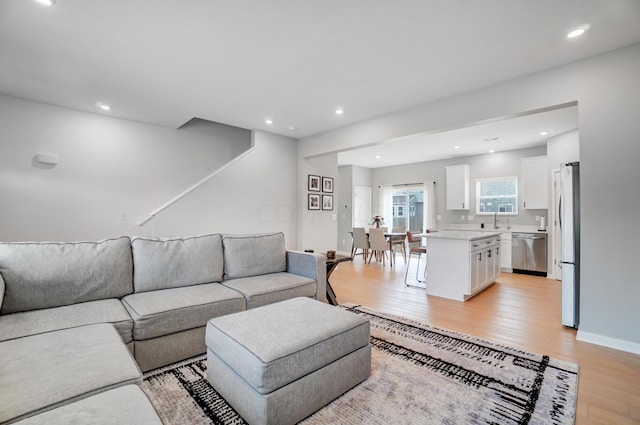 living room featuring light hardwood / wood-style flooring and sink