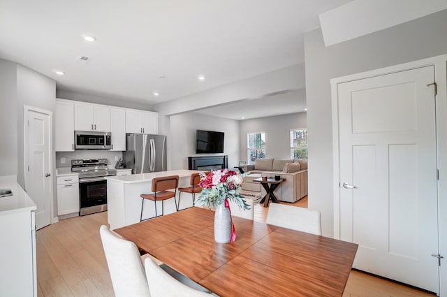 dining space featuring light hardwood / wood-style flooring