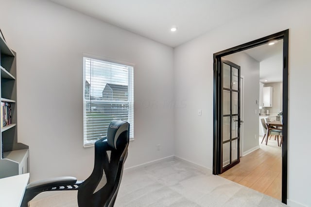 home office with light hardwood / wood-style floors