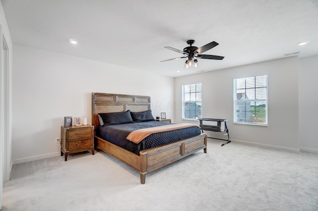 bedroom featuring ceiling fan and light colored carpet