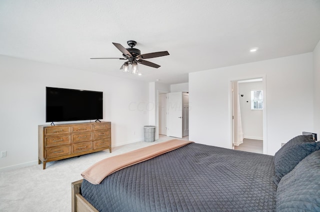 carpeted bedroom featuring connected bathroom and ceiling fan