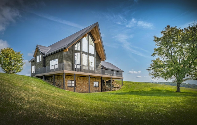 rear view of property featuring a lawn