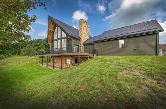 rear view of property with a lawn and a wooden deck