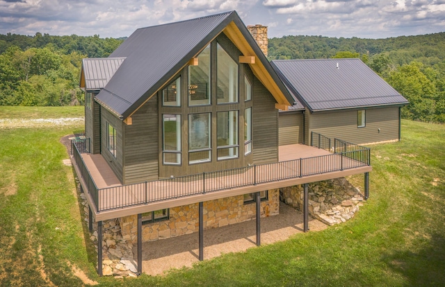 back of property featuring a yard and a wooden deck