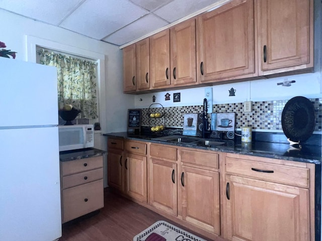 kitchen with a drop ceiling, white appliances, sink, tasteful backsplash, and dark hardwood / wood-style flooring