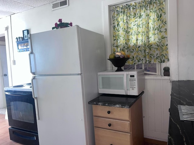 kitchen with wood-type flooring and white appliances