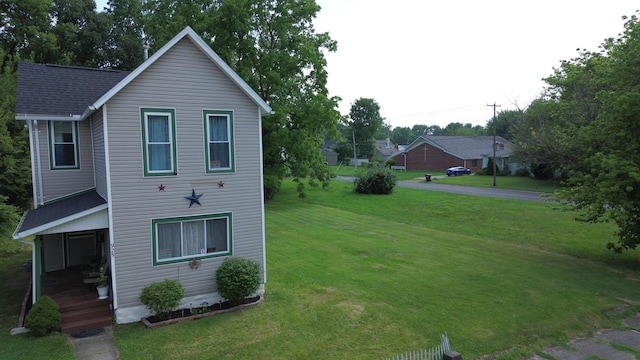 view of side of home with a lawn