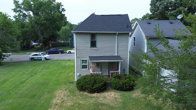 exterior space with covered porch and a yard