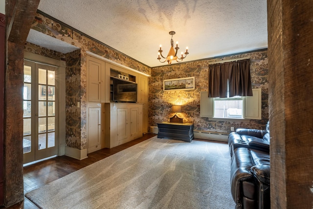 unfurnished room featuring french doors, a textured ceiling, a baseboard heating unit, an inviting chandelier, and dark hardwood / wood-style floors