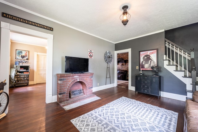 living room with a fireplace, crown molding, dark hardwood / wood-style flooring, and a textured ceiling