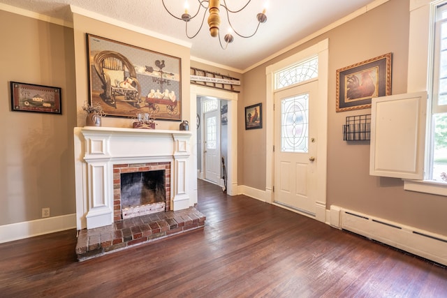 foyer entrance featuring a fireplace, dark hardwood / wood-style flooring, plenty of natural light, and a baseboard heating unit