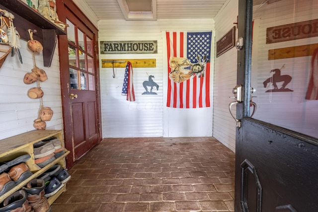 mudroom with wood walls