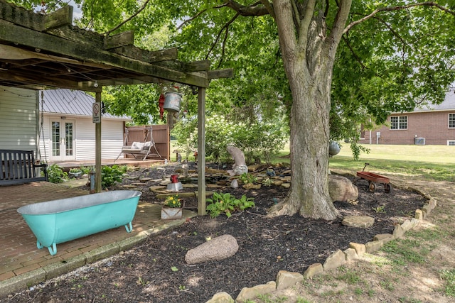 view of yard featuring a pergola, a patio area, and french doors