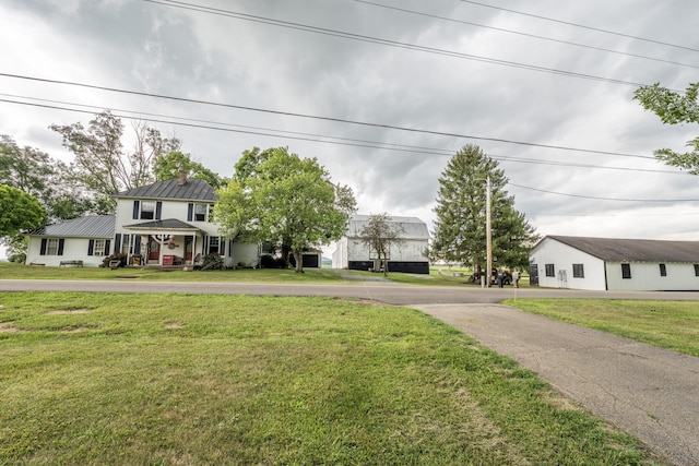 view of front of house featuring covered porch and a front yard