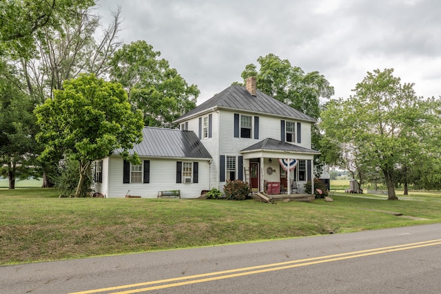 view of front of home with covered porch and a front lawn