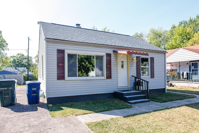 bungalow-style house with a front yard