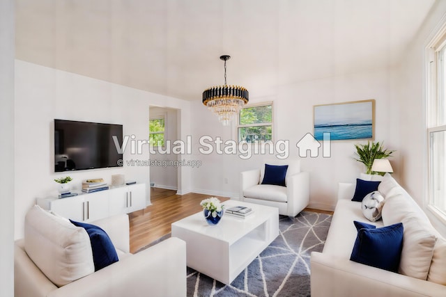 living room featuring dark hardwood / wood-style floors, an inviting chandelier, and plenty of natural light