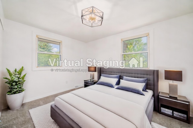 carpeted bedroom featuring multiple windows