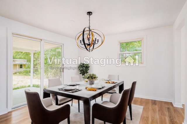 dining space featuring an inviting chandelier, light hardwood / wood-style flooring, and plenty of natural light