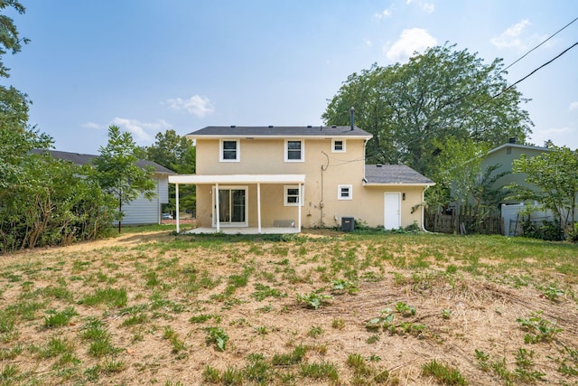 rear view of house with a yard, a patio, and cooling unit