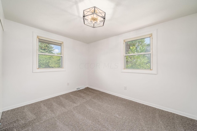 empty room featuring carpet flooring and a healthy amount of sunlight