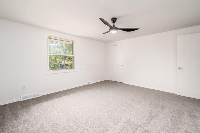 carpeted spare room featuring ceiling fan