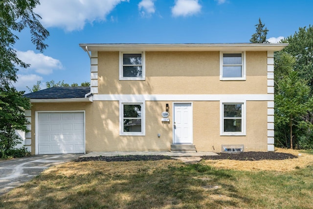 view of front of property featuring a front yard and a garage