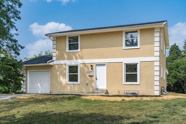 view of front of property featuring a front yard and a garage