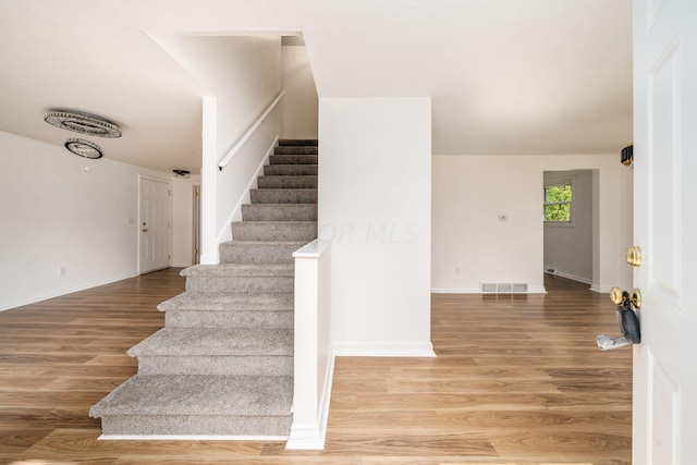 stairs with wood-type flooring