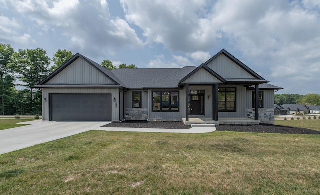 view of front of property featuring covered porch, a garage, and a front lawn