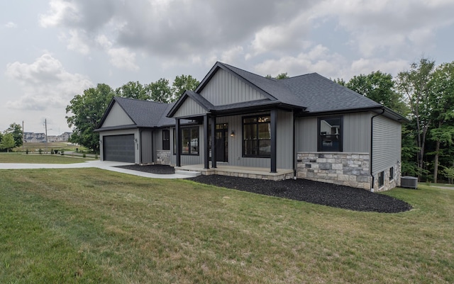 view of front of house featuring a porch, central AC, a garage, and a front lawn