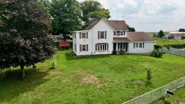 back of house with a lawn