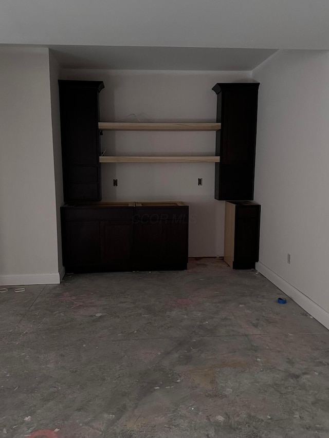 unfurnished living room with concrete flooring