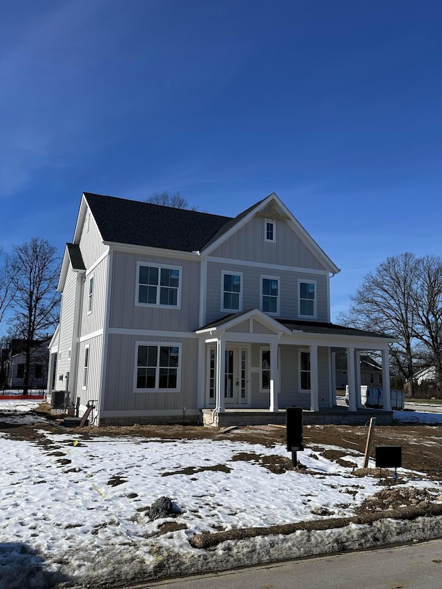 view of front of property with covered porch and central air condition unit