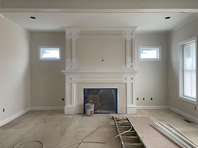 unfurnished living room with a healthy amount of sunlight and a fireplace