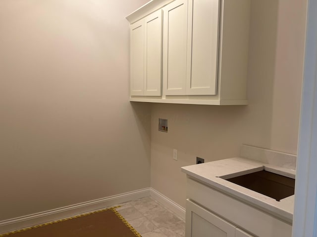 laundry room featuring cabinet space, baseboards, hookup for a washing machine, electric dryer hookup, and a sink