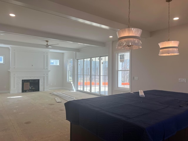 bedroom featuring baseboards, beamed ceiling, a fireplace, and recessed lighting