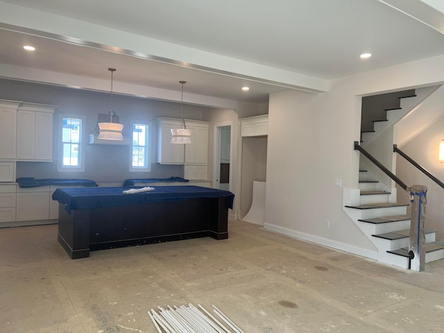 kitchen with recessed lighting, a kitchen island, and white cabinets