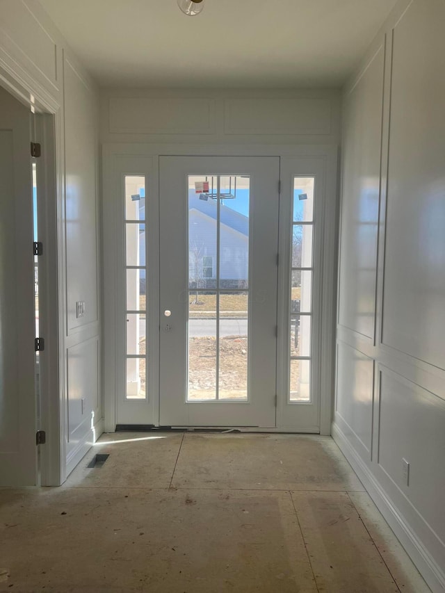 entryway with a wealth of natural light and a decorative wall