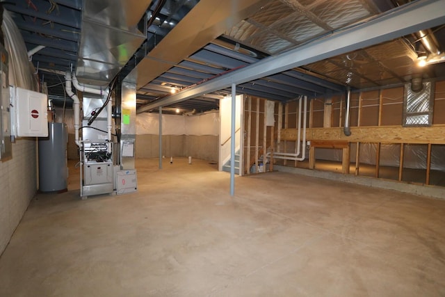 basement featuring electric water heater, heating unit, and electric panel