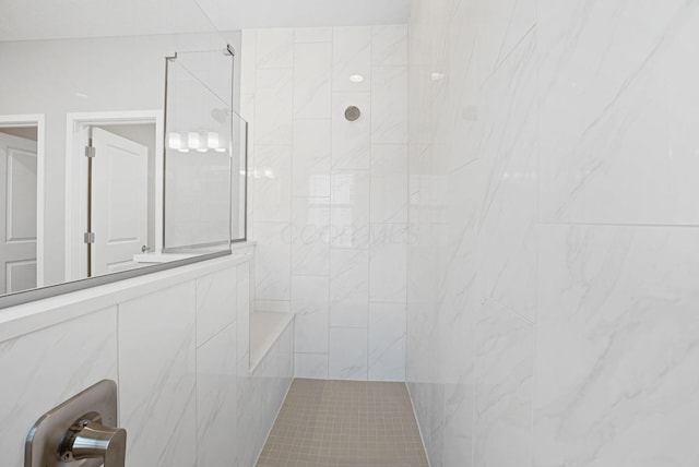 bathroom with a tile shower