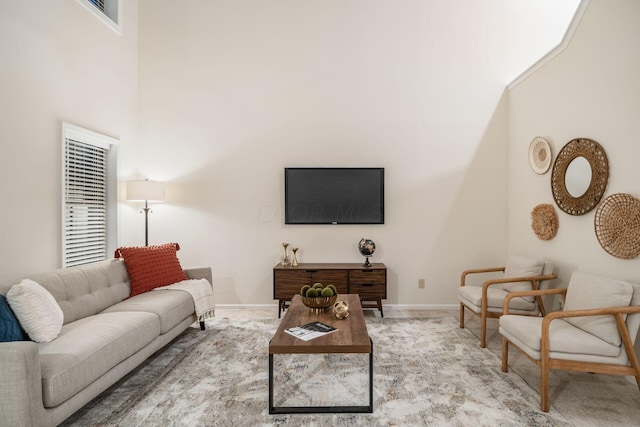 living room featuring carpet flooring and a high ceiling